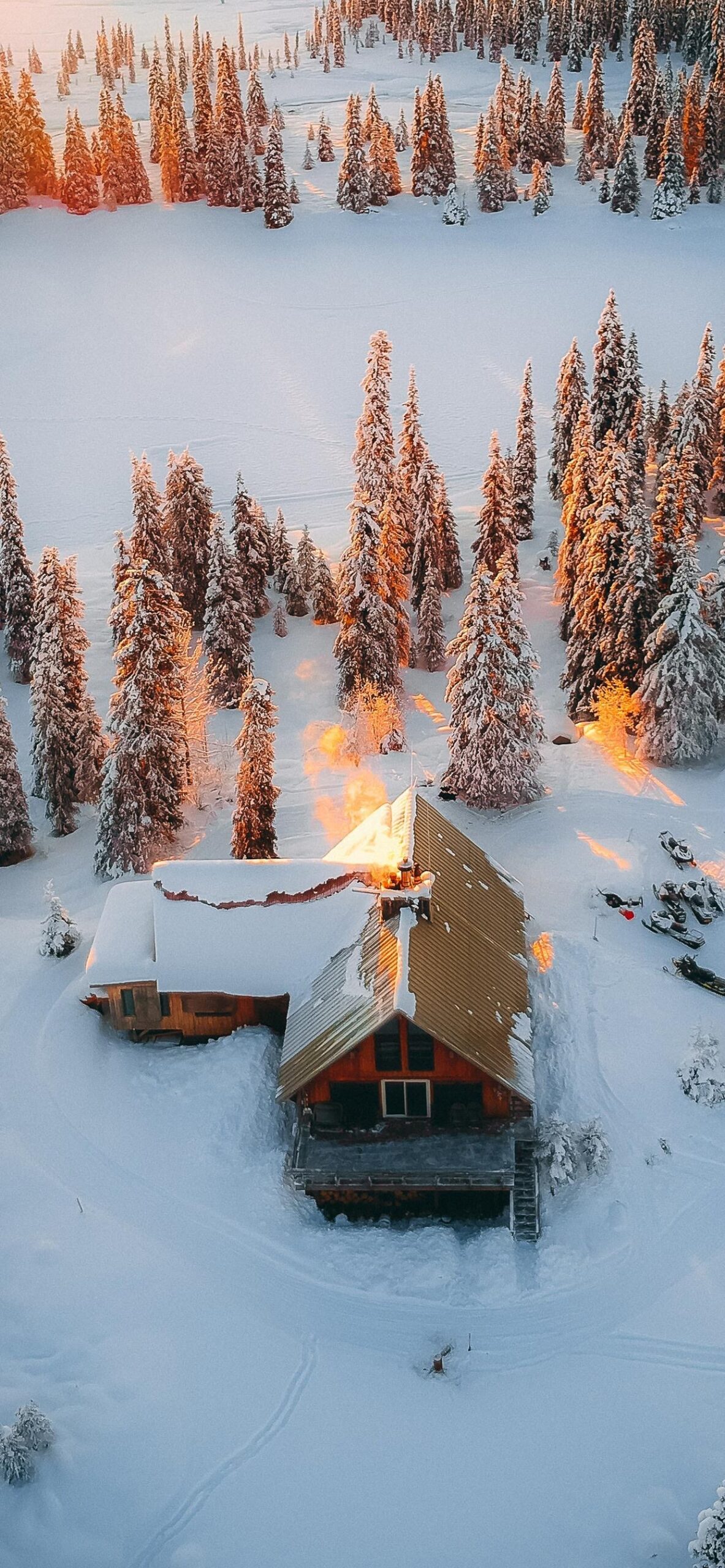 snowy cabin aerial view winter forest