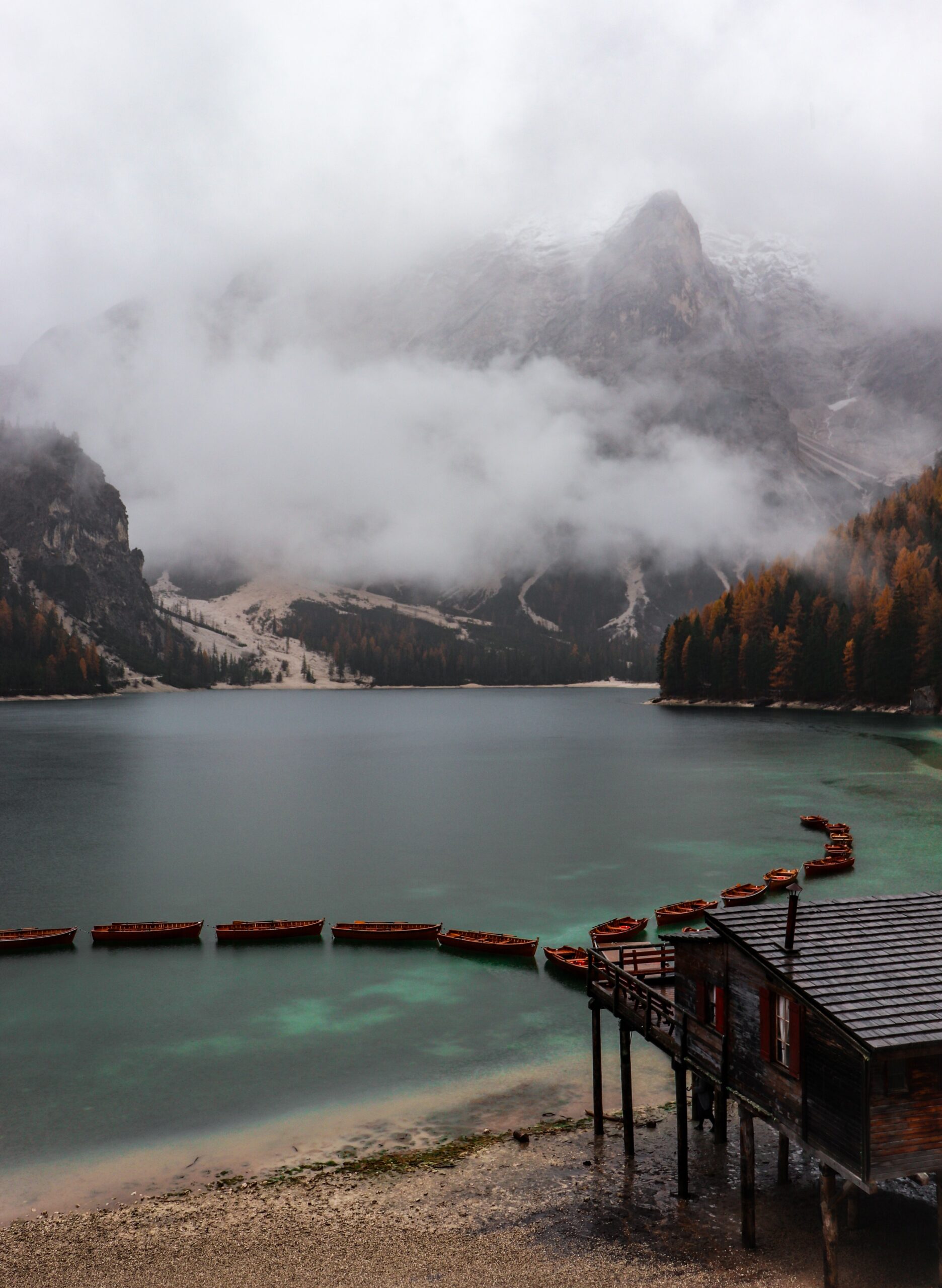 lake mountains fog mist boats braies