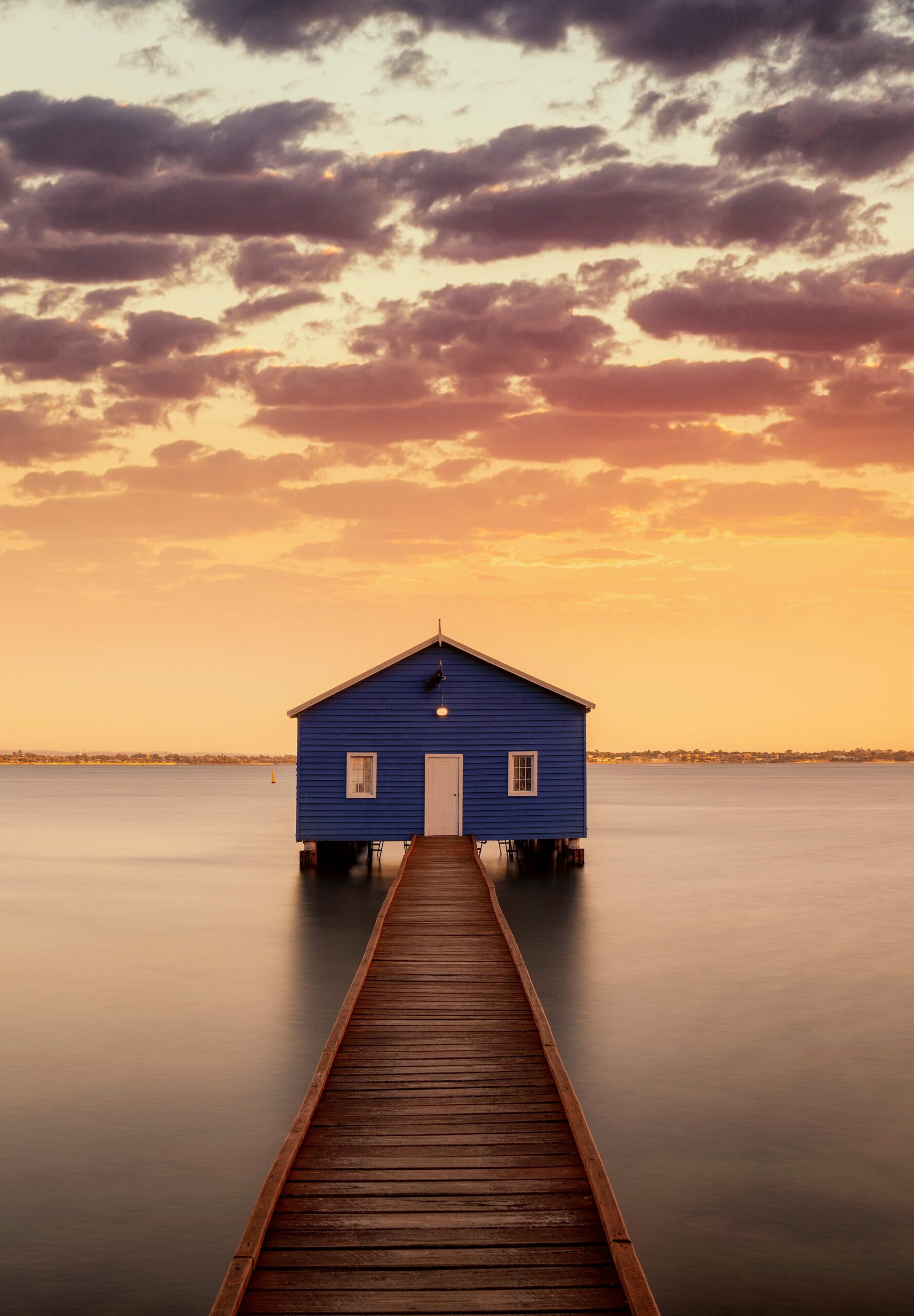 blue boat house pier wooden dock calm